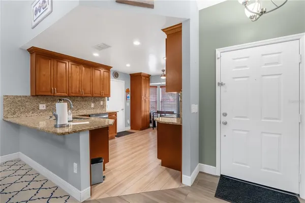 a kitchen with stainless steel appliances granite countertop a refrigerator a sink and a stove
