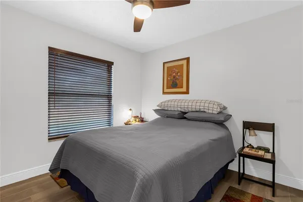 a bedroom with a bed and a painting on the wall