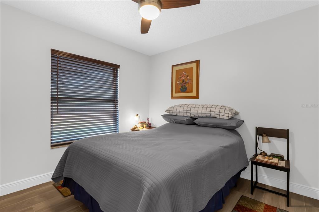 7702 Legacy Lane Orlando, FL 32818 - Photo 18 of 21 a bedroom with a bed and a painting on the wall