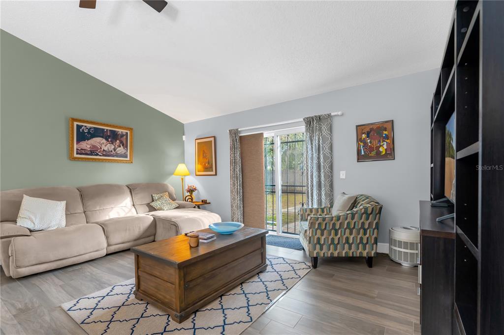 7702 Legacy Lane Orlando, FL 32818 - Photo 6 of 21 a living room with furniture and a floor to ceiling window