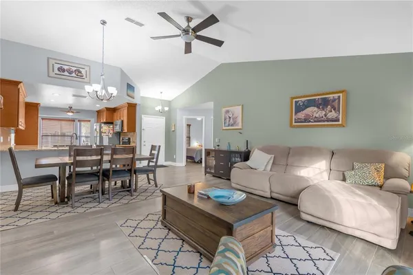 a living room with furniture and a chandelier