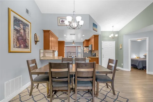 a view of a dining room with furniture and a chandelier