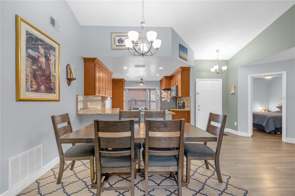 7702 Legacy Lane Orlando, FL 32818 - Photo 10 of 21 a view of a dining room with furniture and a chandelier