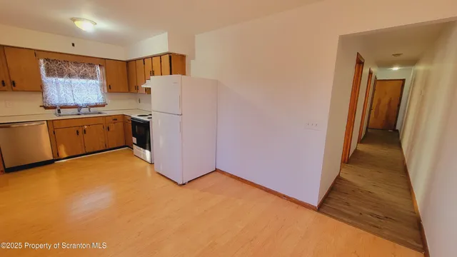 a view of a kitchen with a sink cabinets and a refrigerator
