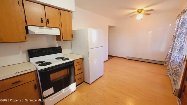 a kitchen with a stove and a refrigerator