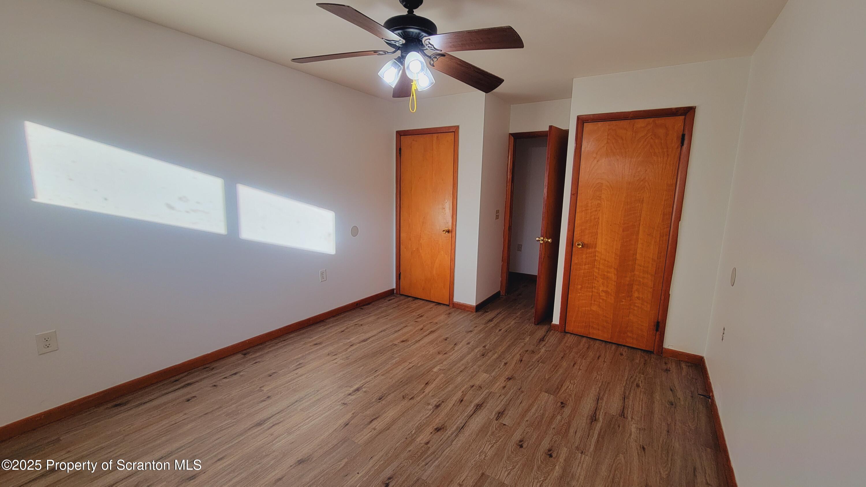 712 Alder Street, Unit FIRST Scranton, PA 18505 - Photo 9 of 18 a view of an empty room with window and wooden floor