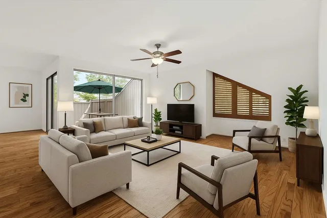 a living room with furniture a fireplace and a large window