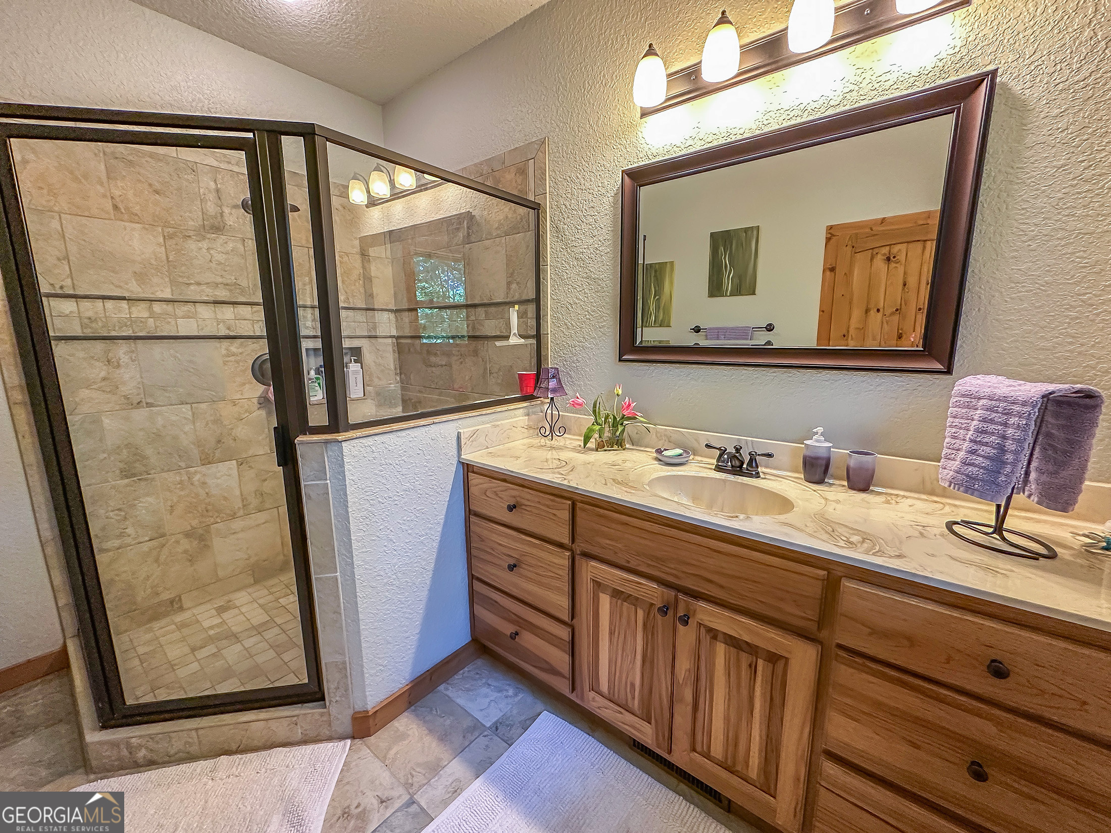 181 Morgan Ridge Court Young Harris, GA 30582 - Photo 19 of 37 a bathroom with a double vanity sink and a mirror