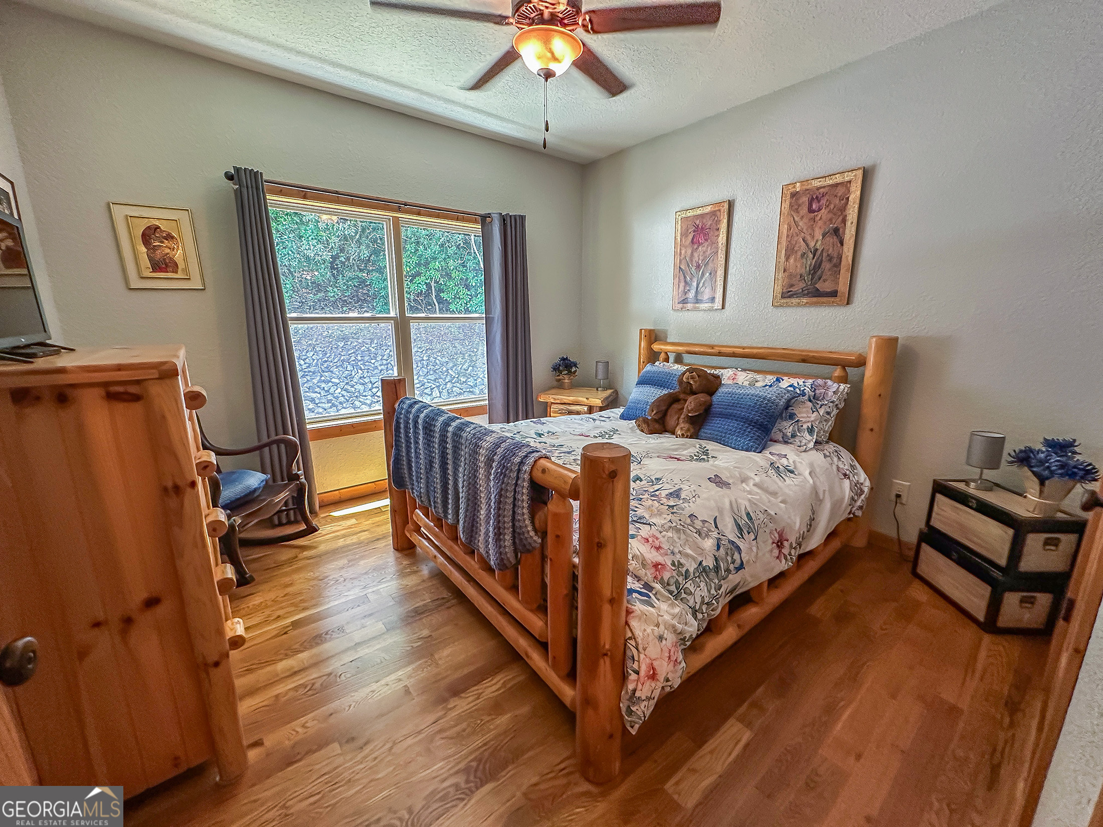 181 Morgan Ridge Court Young Harris, GA 30582 - Photo 20 of 37 a bedroom with a bed and a chandelier