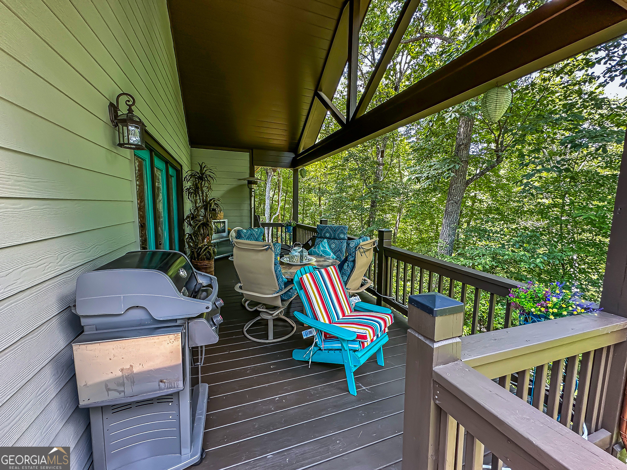 181 Morgan Ridge Court Young Harris, GA 30582 - Photo 5 of 37 a view of deck with a table and chairs with wooden floor and stairs