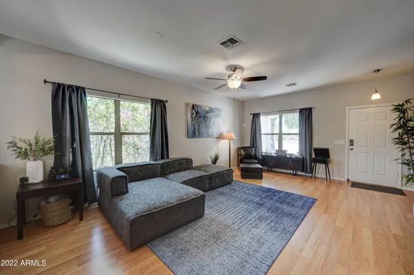 a living room with furniture and a wooden floor