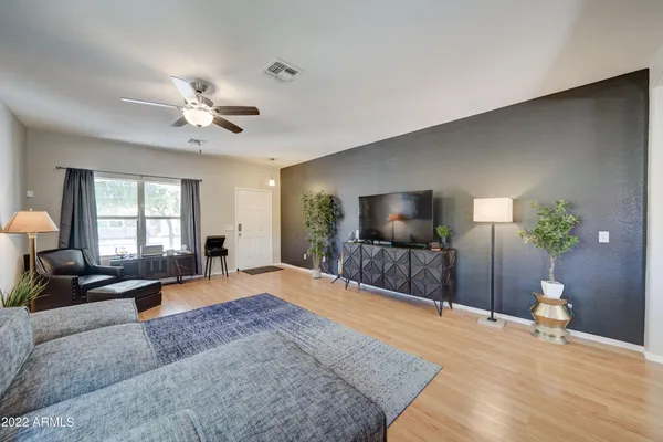 a spacious bedroom with a bed and a flat screen television