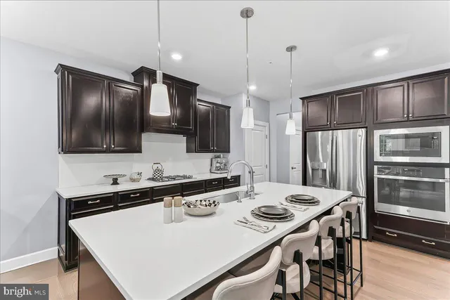 a kitchen with a stove a refrigerator and a sink