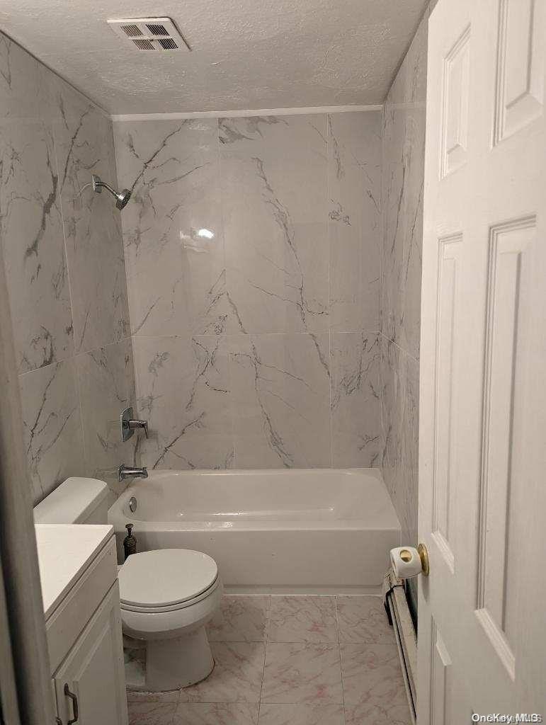555 Eldert Lane Brooklyn, NY 11208 - Photo 6 of 6 a bathroom with a toilet and a shower