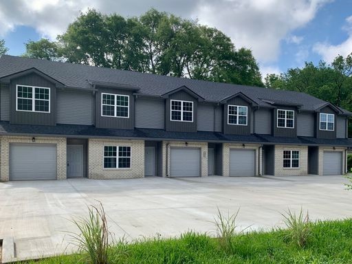 a house that has a tree in front of it