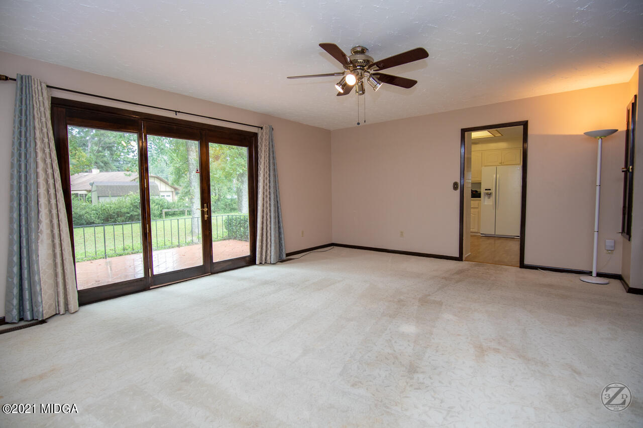 1027 Country Club Road Perry, GA 31069 - Photo 12 of 55 a view of a livingroom with a ceiling fan and window