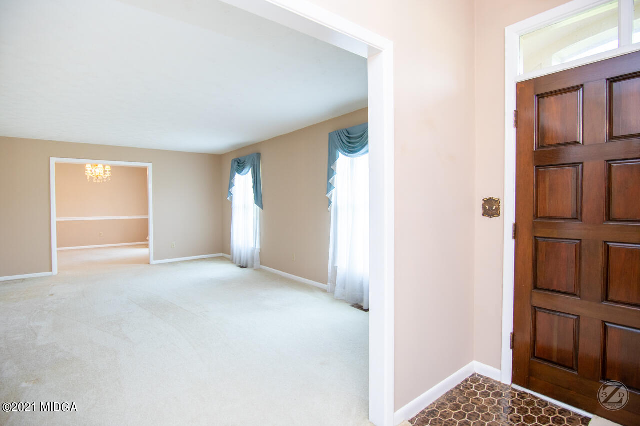 1027 Country Club Road Perry, GA 31069 - Photo 17 of 55 a view of an empty room and kitchen