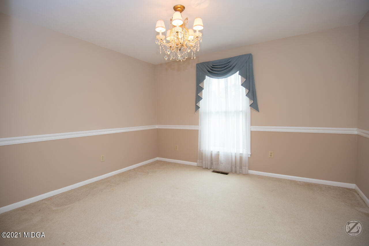 1027 Country Club Road Perry, GA 31069 - Photo 20 of 55 a view of an empty room with a window