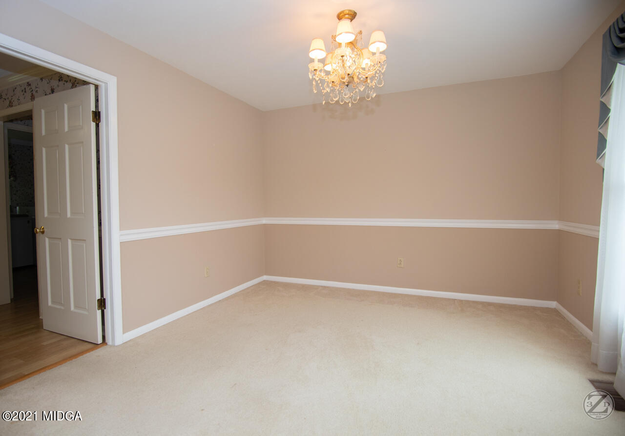 1027 Country Club Road Perry, GA 31069 - Photo 21 of 55 wooden floor in an empty room