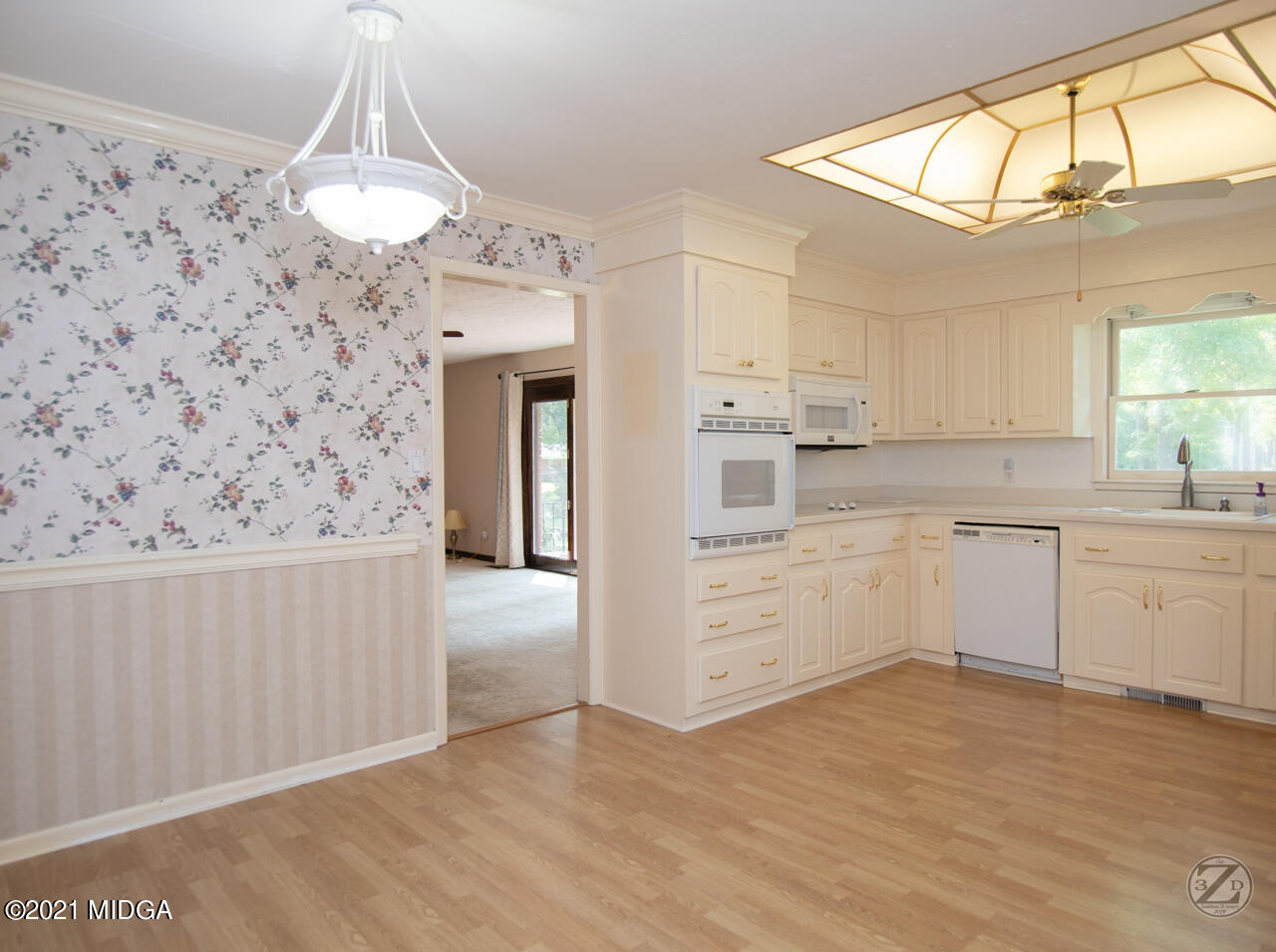 1027 Country Club Road Perry, GA 31069 - Photo 23 of 55 a kitchen with granite countertop white cabinets and white appliances