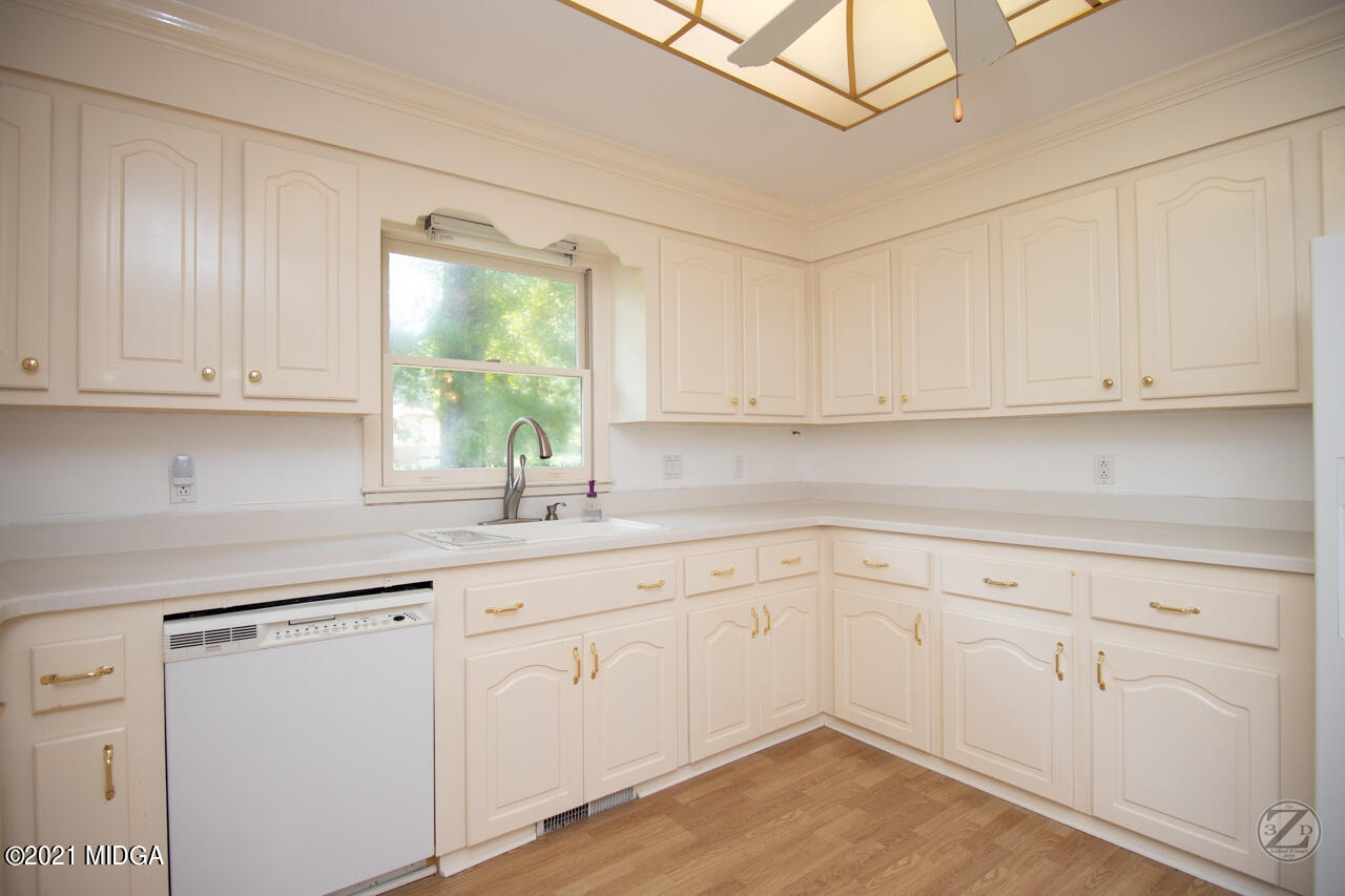 1027 Country Club Road Perry, GA 31069 - Photo 29 of 55 a kitchen with white cabinets white appliances and a sink