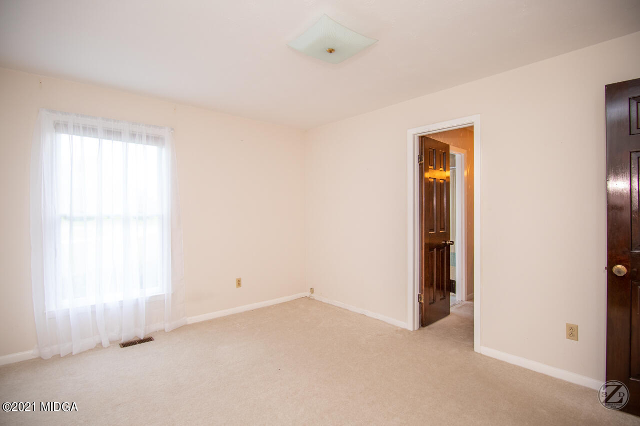 1027 Country Club Road Perry, GA 31069 - Photo 32 of 55 a view of an empty room with a window