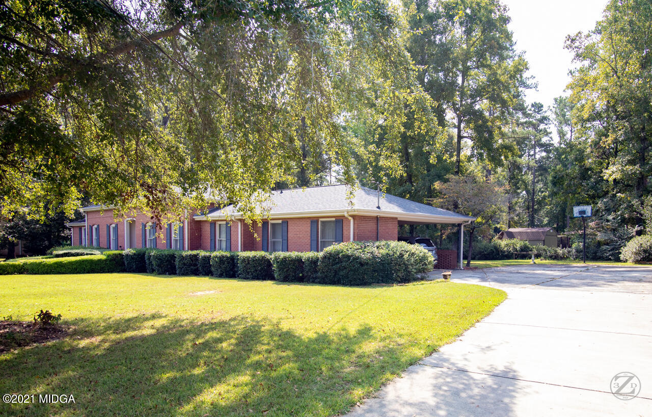 1027 Country Club Road Perry, GA 31069 - Photo 5 of 55 a front view of a house with a yard and trees