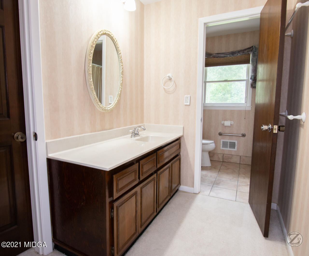 1027 Country Club Road Perry, GA 31069 - Photo 46 of 55 a bathroom with a sink a toilet and a mirror