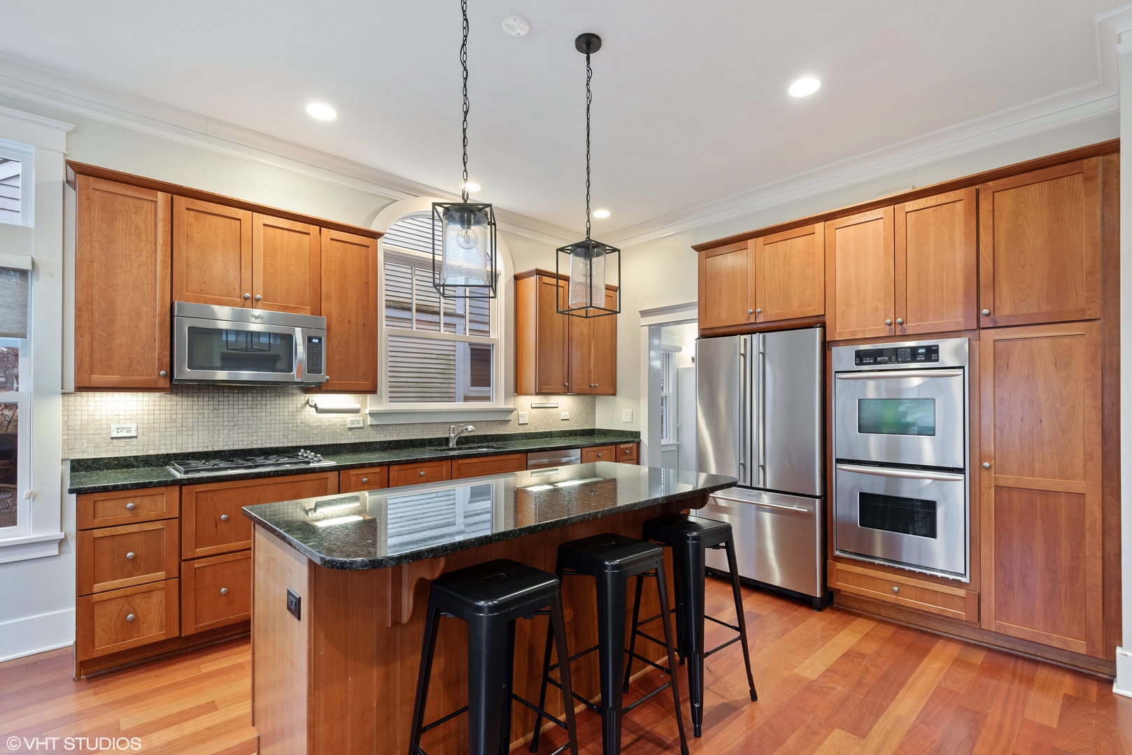 2121 Forestview Road Evanston, IL 60201 - Photo 13 of 35 a kitchen with stainless steel appliances granite countertop a refrigerator a stove and a wooden floors