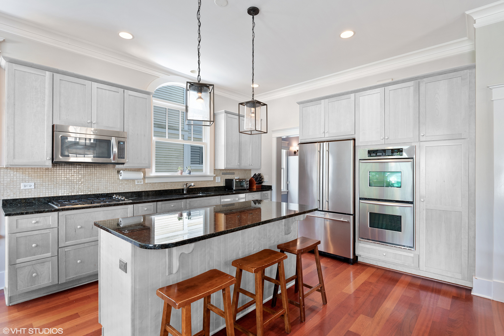 2121 Forestview Road Evanston, IL 60201 - Photo 34 of 35 a kitchen with stainless steel appliances granite countertop a refrigerator a stove a sink and white cabinets with wooden floor