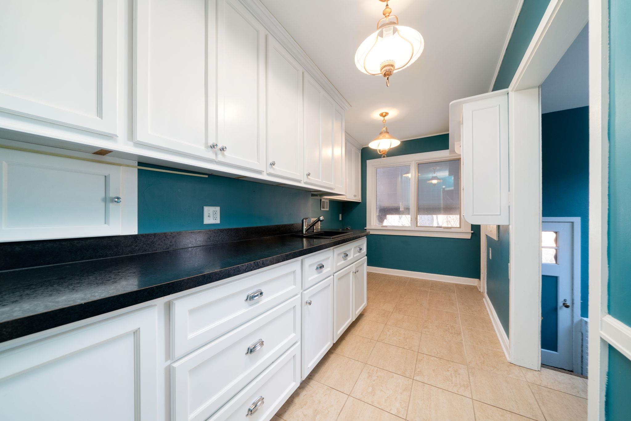 959 North River Road Oregon, IL 61061 - Photo 12 of 63 a kitchen with granite countertop white cabinets and stainless steel appliances