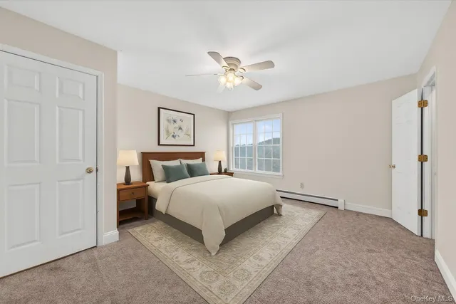 a spacious bedroom with a bed and a window