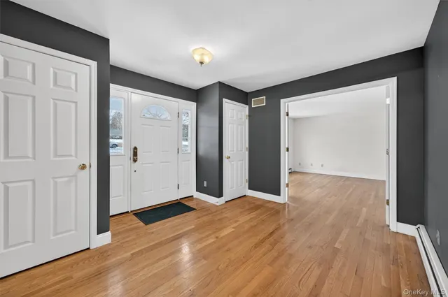 a view of an entryway with wooden floor