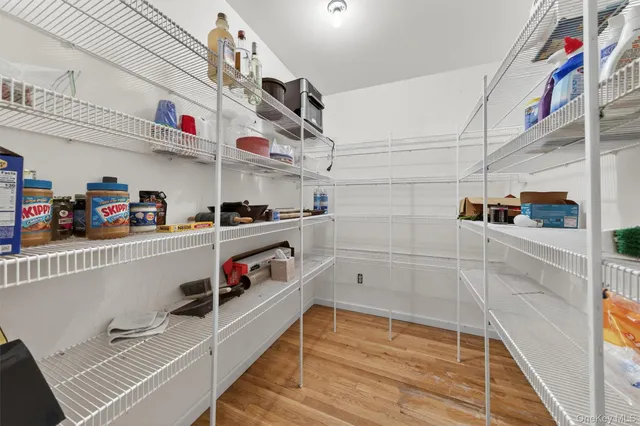 a utility room with lots of clutter and cabinets