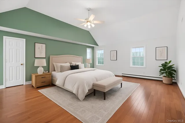 a bedroom with a large bed and a chandelier