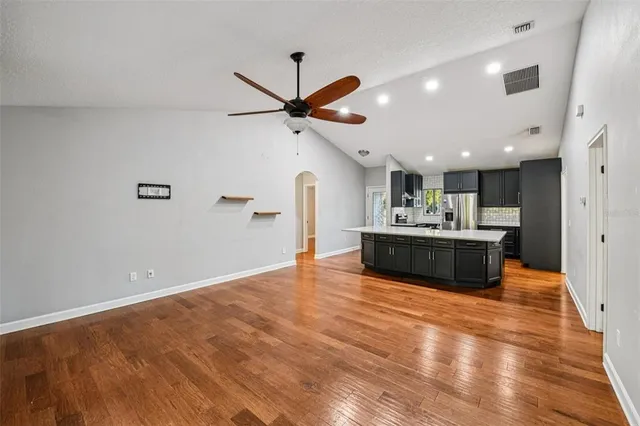 a view of kitchen with a sink and a refrigerator