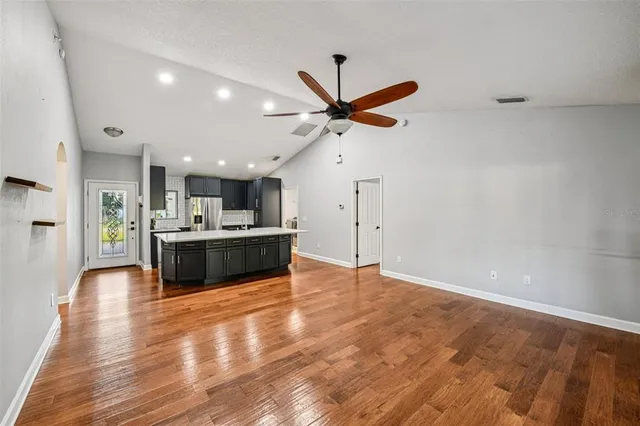 a view of kitchen with refrigerator and microwave