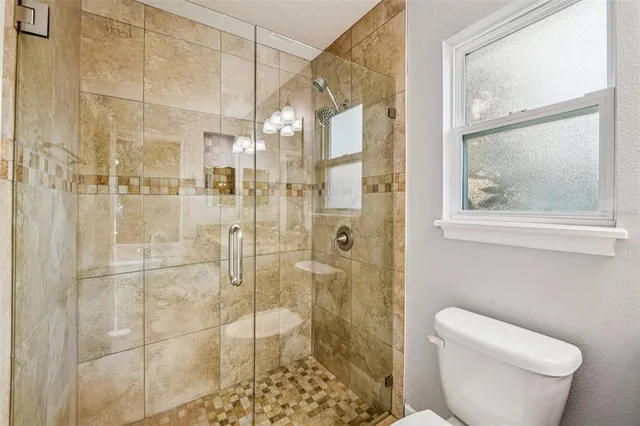 a bathroom with a shower and toilet