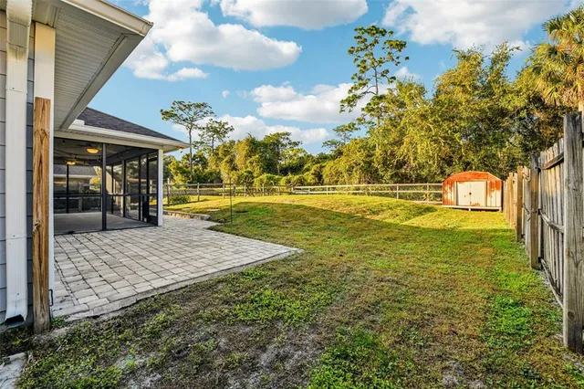 a view of an ocean & house with a yard