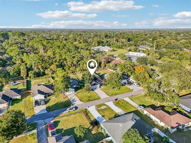 an aerial view of residential houses with outdoor space