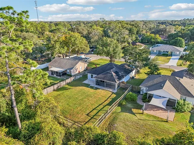 an aerial view of residential houses with outdoor space and swimming pool