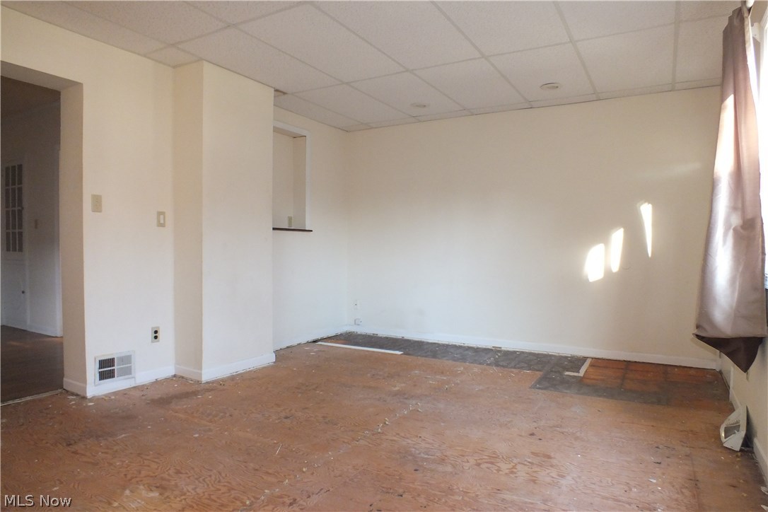 3844 Bethany Road Cleveland, OH 44118 - Photo 11 of 35 The large family room which does need your choice of finished flooring. This room has a large picture window and a door leading to the back garden