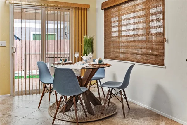 a dining room with furniture and window