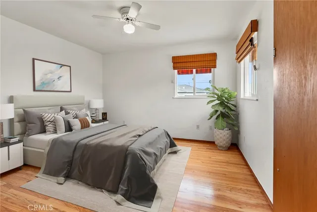 a bed room with a bed and a potted plant