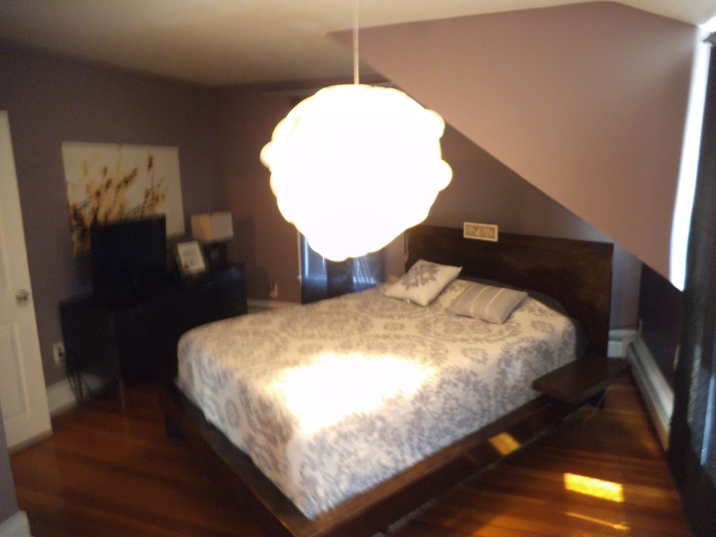 549 Buffinton Street Fall River, MA 02721 - Photo 15 of 17 a bed sitting in a bedroom next to a window