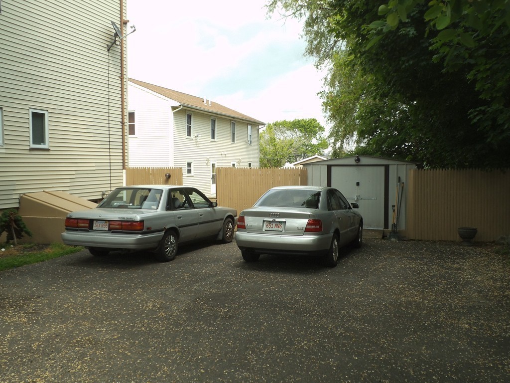 549 Buffinton Street Fall River, MA 02721 - Photo 4 of 17 a couple of cars parked in front of a house