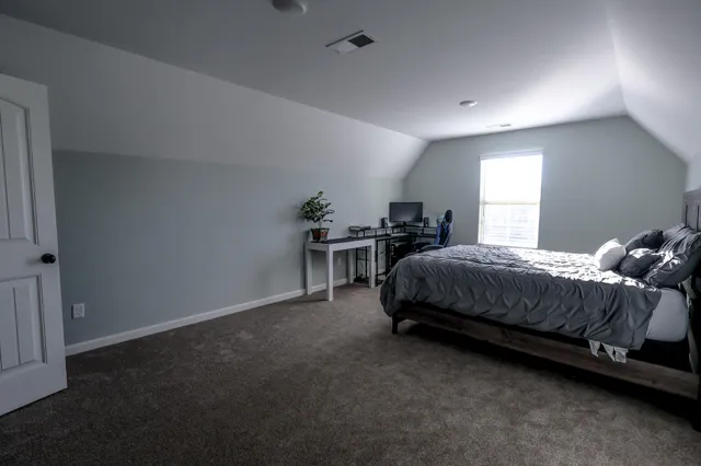 a view of a kitchen with white cabinets