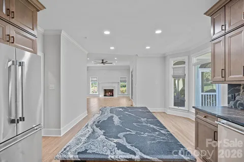 a spacious bathroom with a granite countertop sink a mirror and a shower