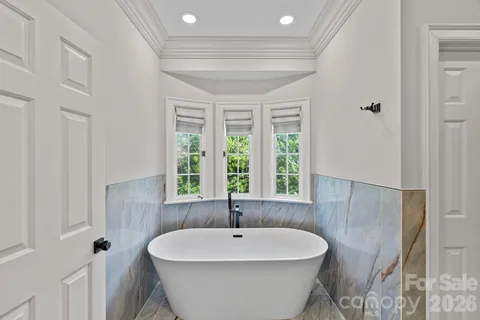 a bathroom with a granite countertop shower and a sink