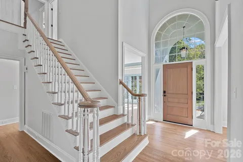 a view of entryway and hall with wooden floor